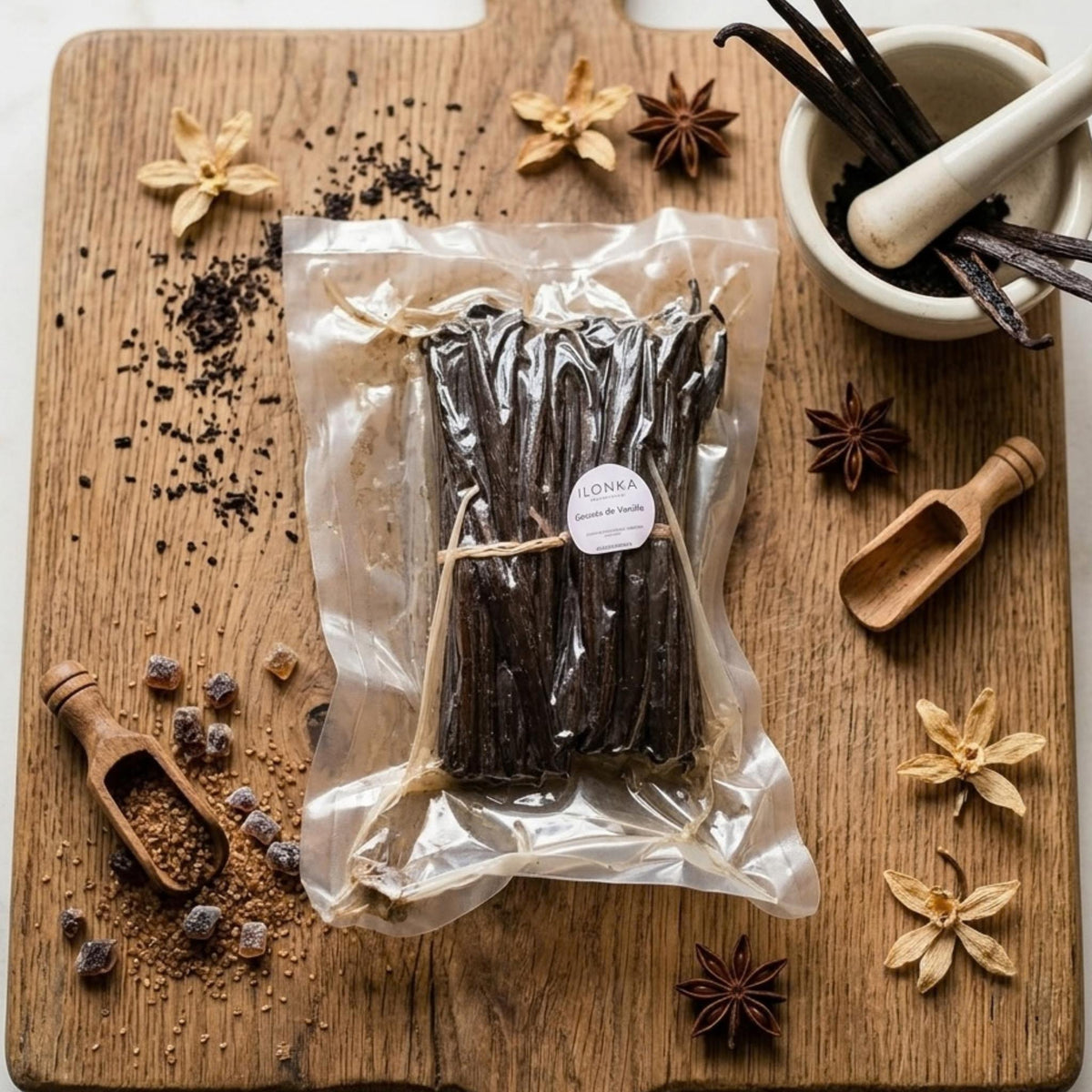 Bourbon Vanilla Beans from Madagascar | Ilonka – 1 kg vacuum pack of vanilla beans on a wooden board with spices
