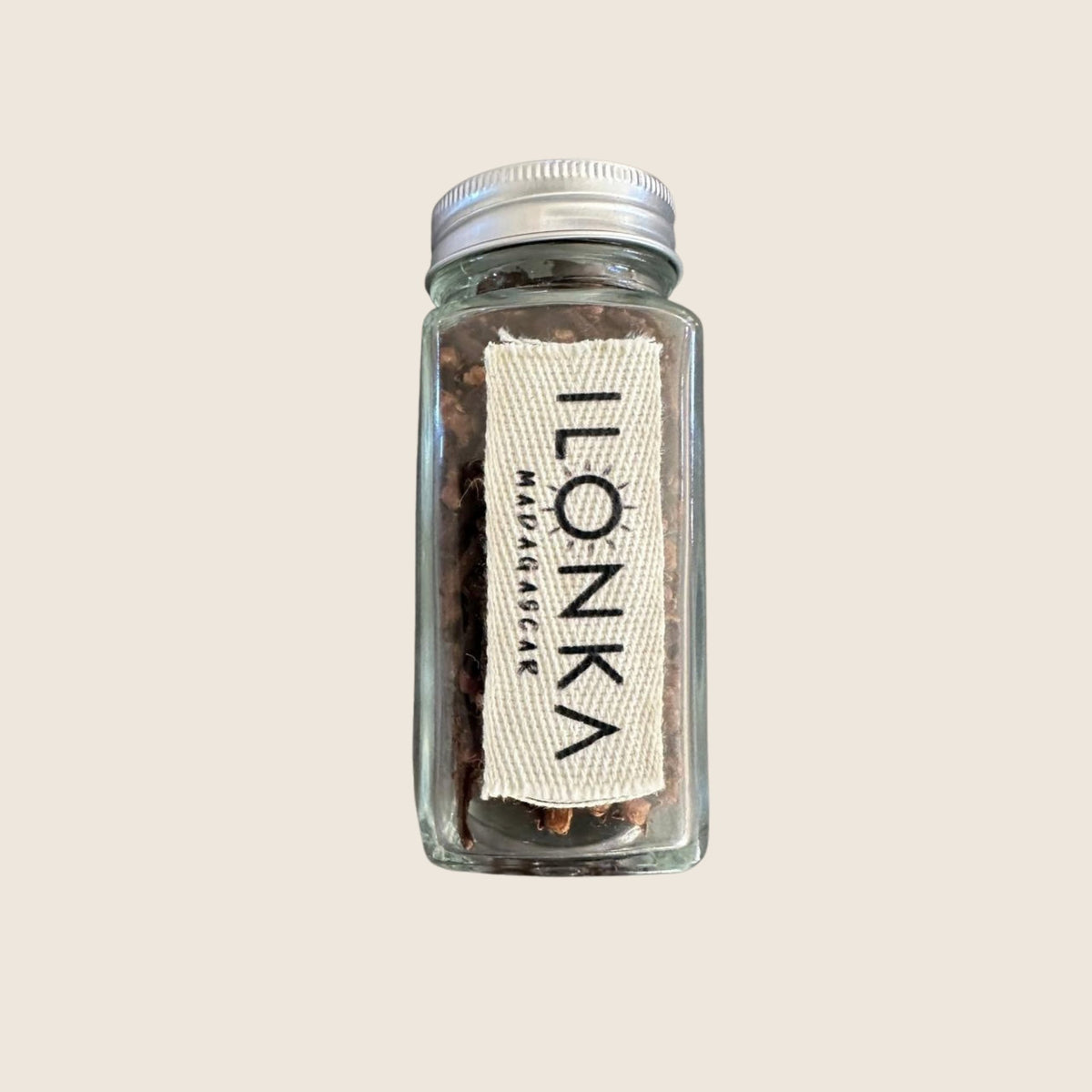 Cloves from Madagascar | Ilonka – glass jar of whole cloves on beige background